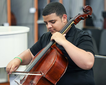 Male student playing Cello.
