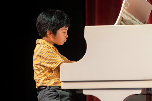 Student playing the piano.