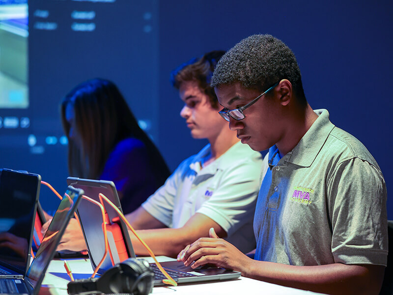 Students sitting at computers in the ETIC video production room.